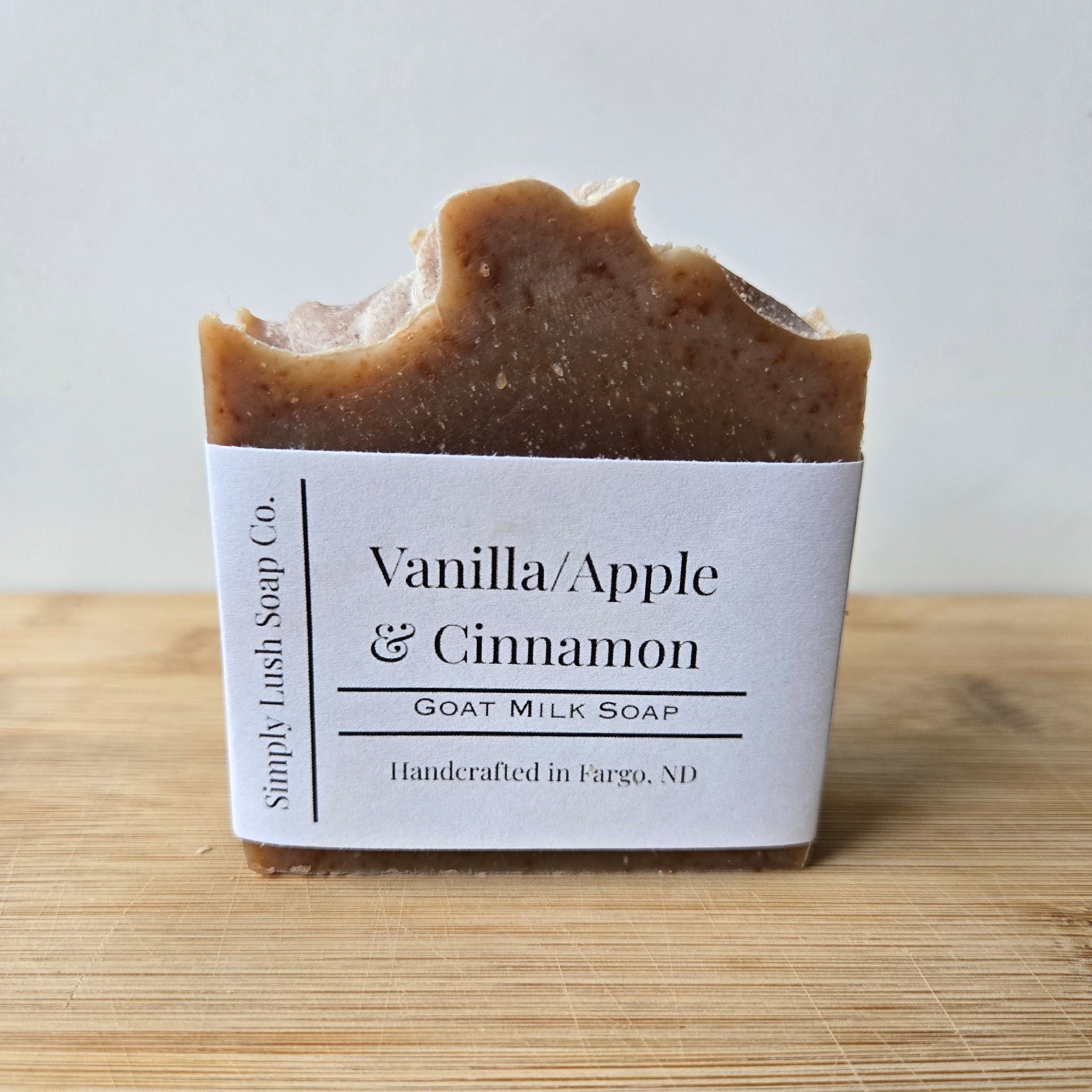 Bar of soap with a label on a wooden block